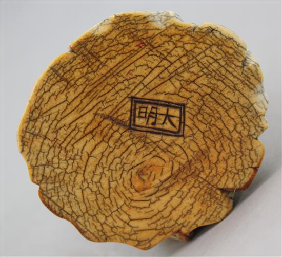 A Chinese mammoth ivory tusk carving of a seated figure of Li Bai, 20th century, 14cm, wood stand